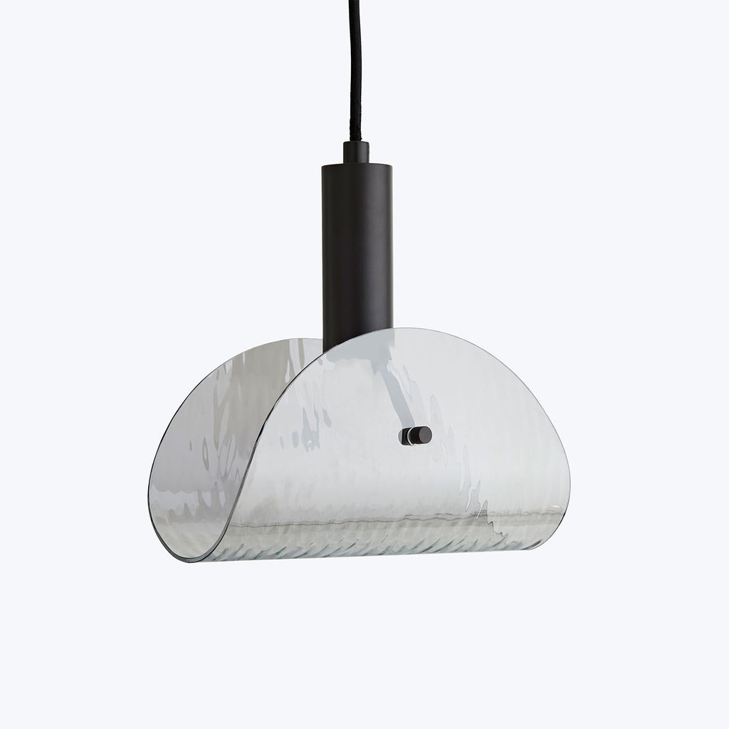 Modern pendant light with glossy, reflective chrome finish hangs elegantly.