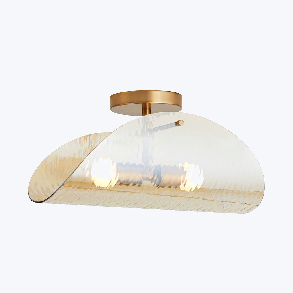 Sleek and contemporary ceiling light fixture with warm, textured glow.