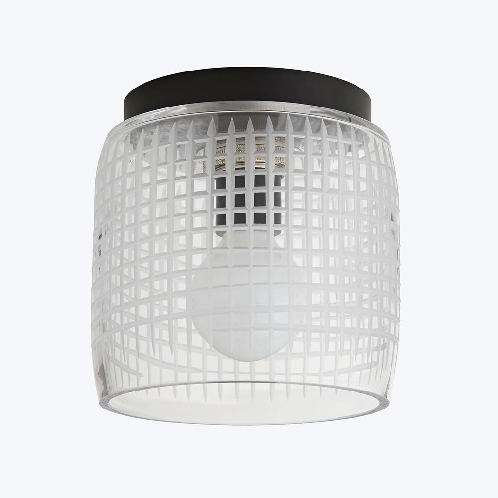 Modern cylindrical flush mount ceiling light with geometric grid design.