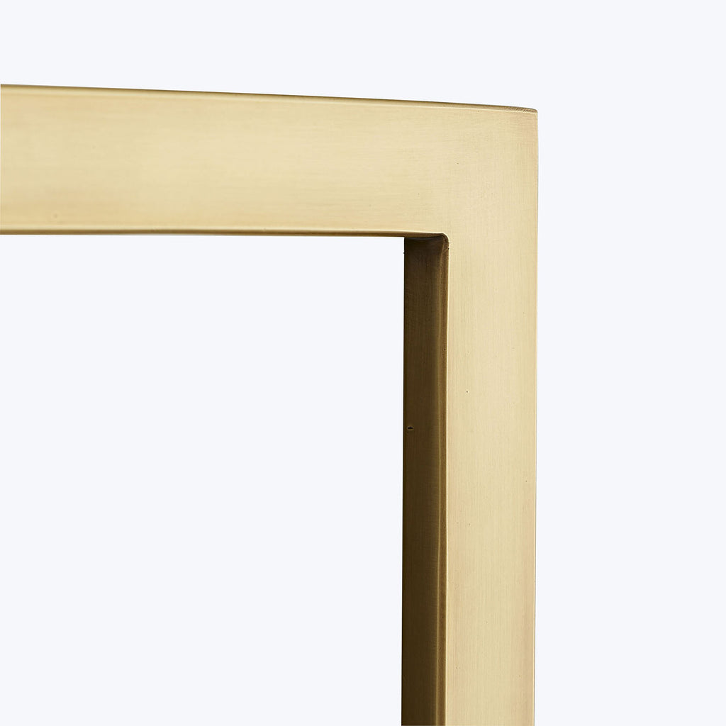 Close-up of a modern, minimalistic gold picture frame with fine craftsmanship.
