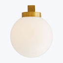 Minimalist white orb light fixture with gold cap on top.