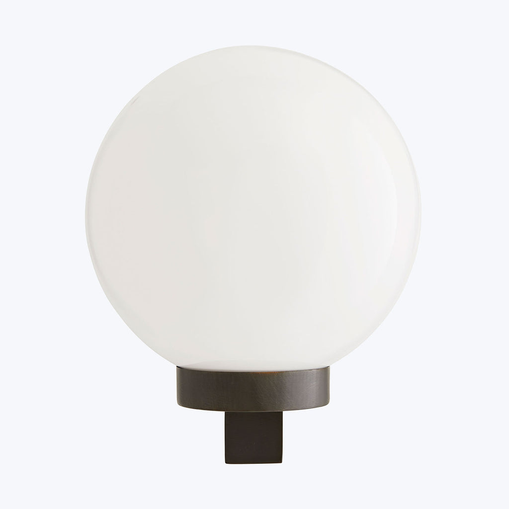 Sleek, minimalist lamp with a frosted glass cover, emitting soft light.