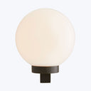 A modern, minimalist lamp emitting soft, diffused light on dark base.