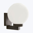 A sleek and minimalistic wall-mounted light fixture with a bright globe.