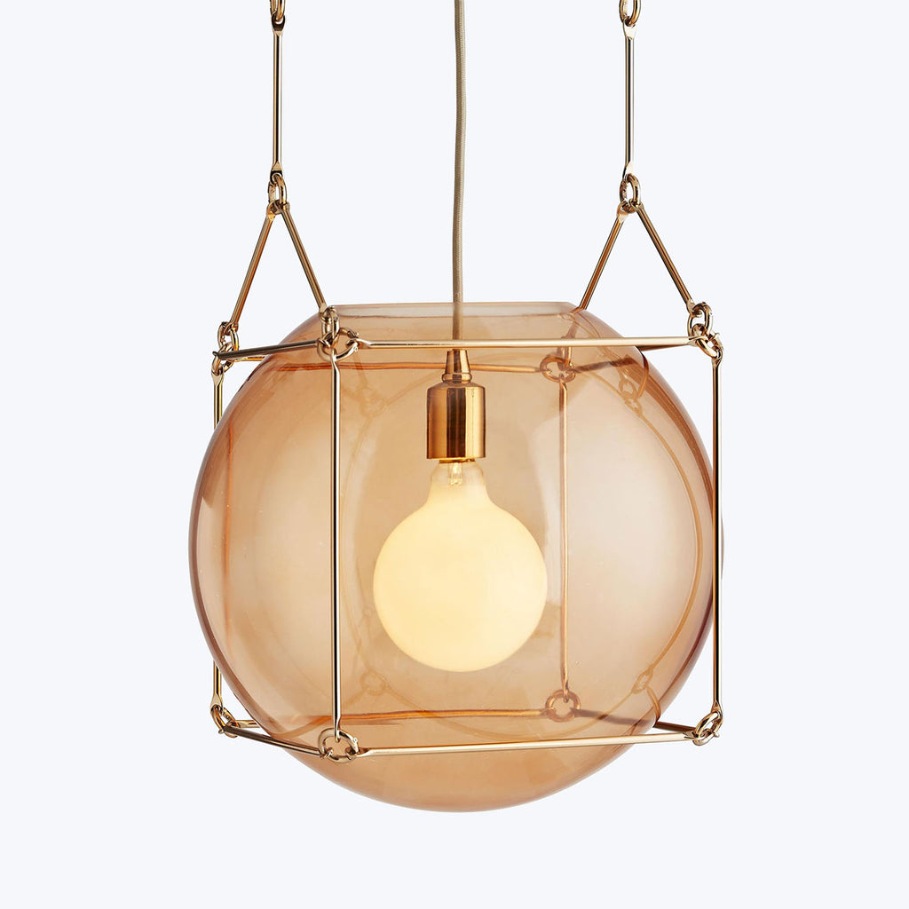 Contemporary pendant light with warm amber shade and elegant framework.