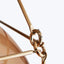 Close-up of a golden metal ring on a fashionable accessory.