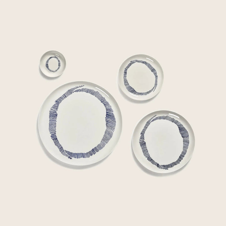 Modern ceramic dishes with blue circular pattern, clean aesthetic design.