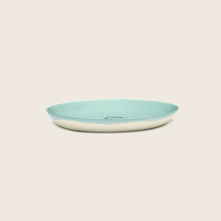 Simple ceramic plate with two-tone color scheme on white background.