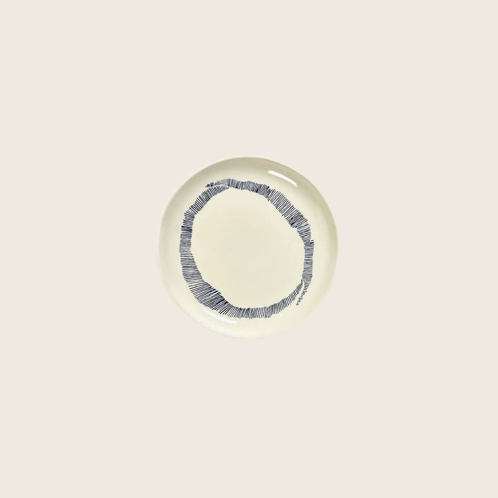 Modern ceramic plate with black line border on white background.