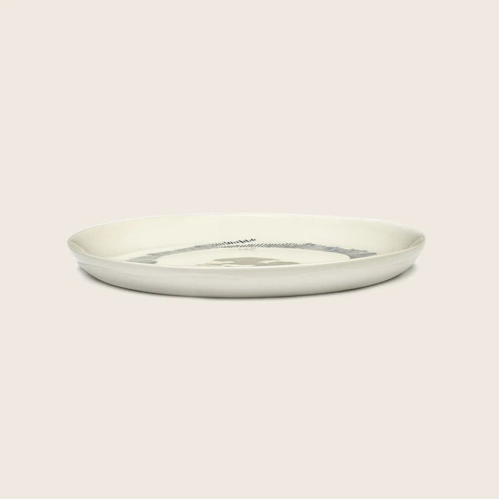 Simple round plate with raised edge on white background.