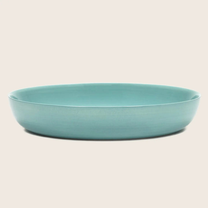 Round blue ceramic dish with matte glaze, perfect for serving
