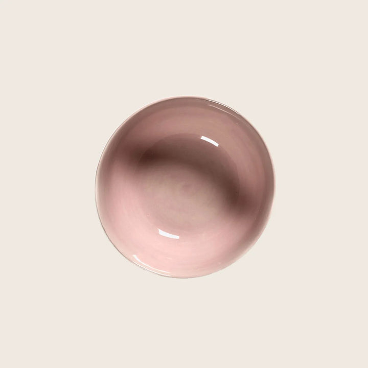 Minimalistic pink bowl with soft shadow on light gray background.