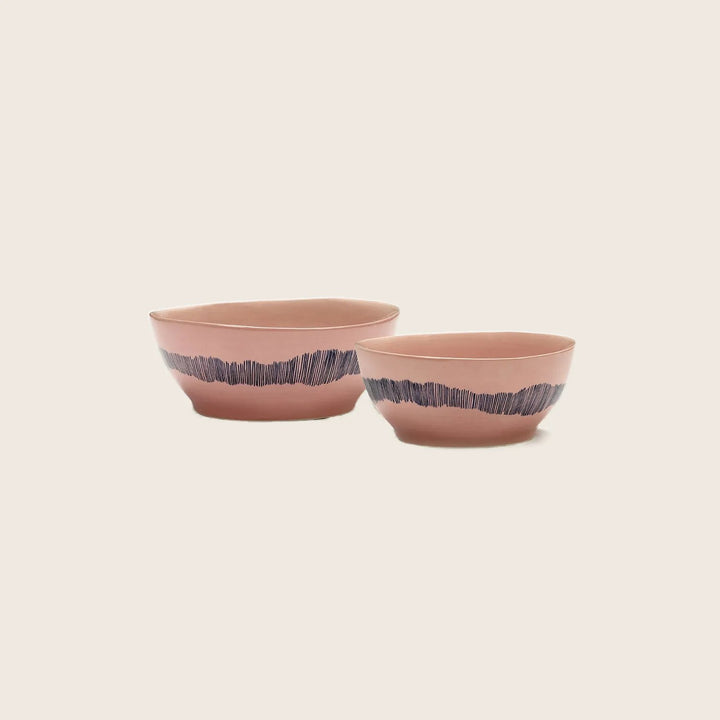 Two round ceramic bowls with modern design on white background.
