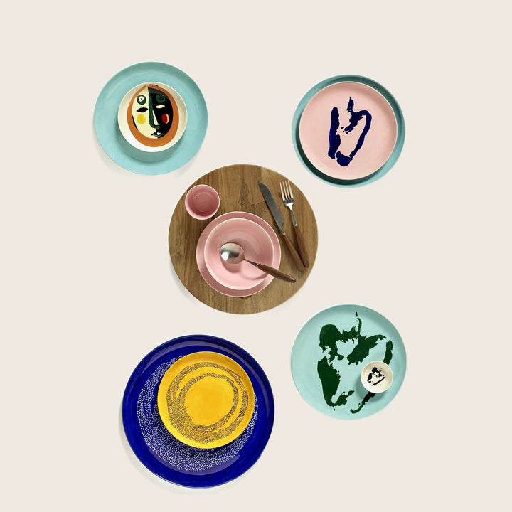 Collection of five uniquely designed plates against a white background.
