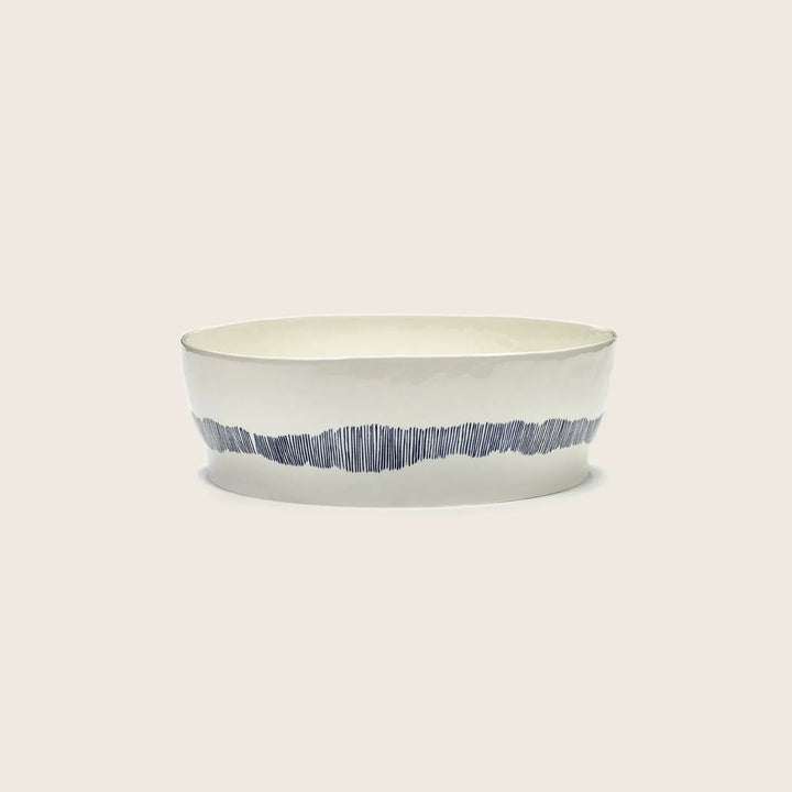 Minimalist two-tone ceramic bowl with broad base and wide opening.