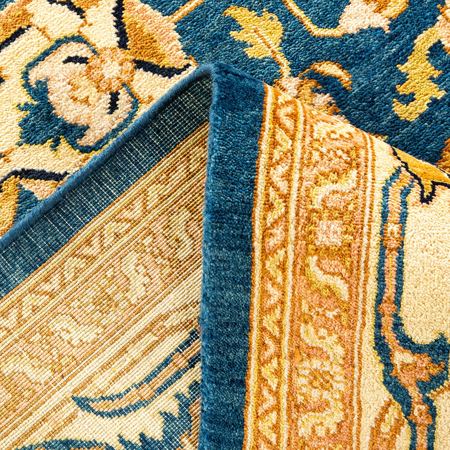 Close-up of a high-quality rug with contrasting blue and cream designs.