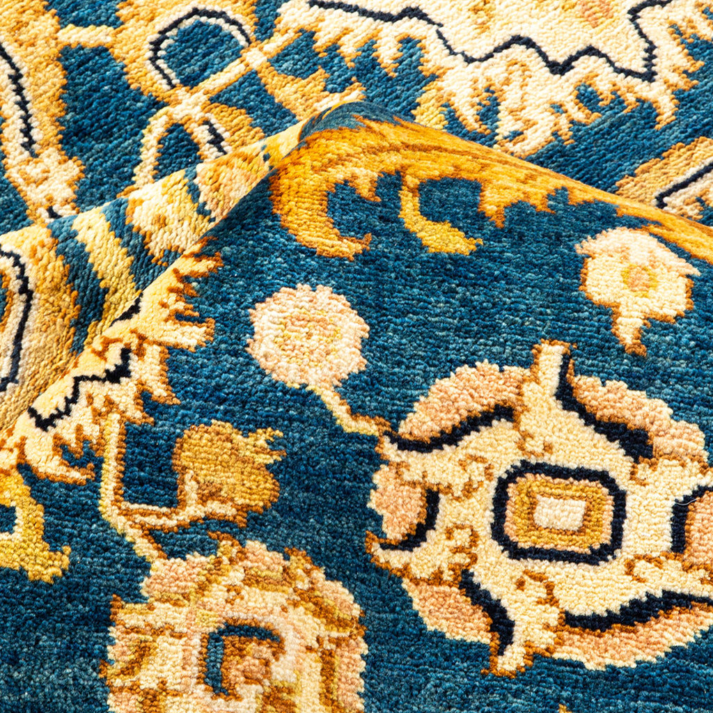 Close-up of a traditional, blue and gold patterned rug. Handcrafted and thick.