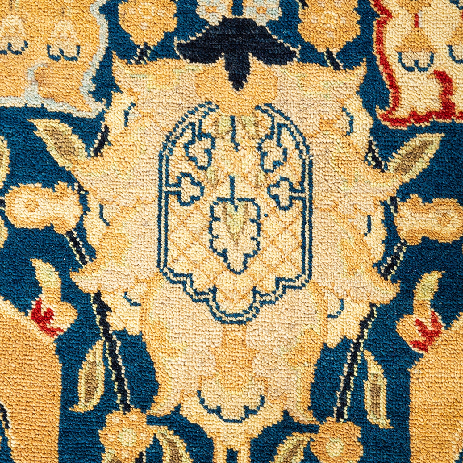 Elaborate Oriental-inspired rug with intricate patterns in blue and gold.