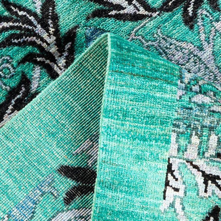 Close-up of folded textile revealing intricate, detailed pattern and texture.