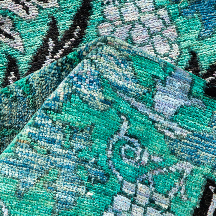 Vibrant, intricately patterned fabric with a textured, plush appearance.