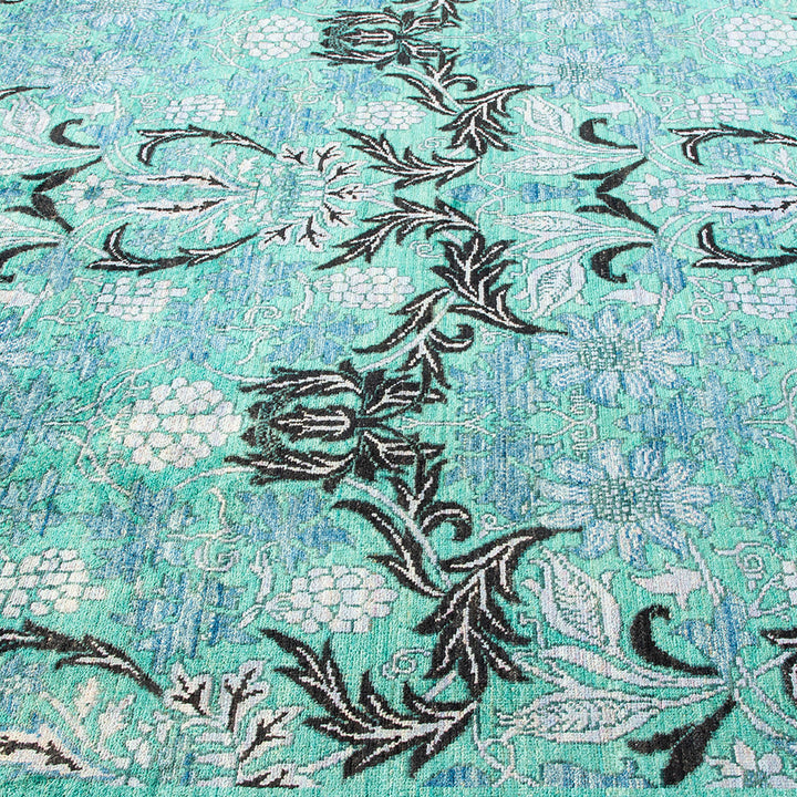 Intricate floral carpet design with watercolor effect in shades of blue.