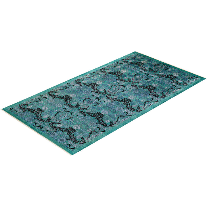 Vintage teal rug with intricate floral pattern displayed against white.