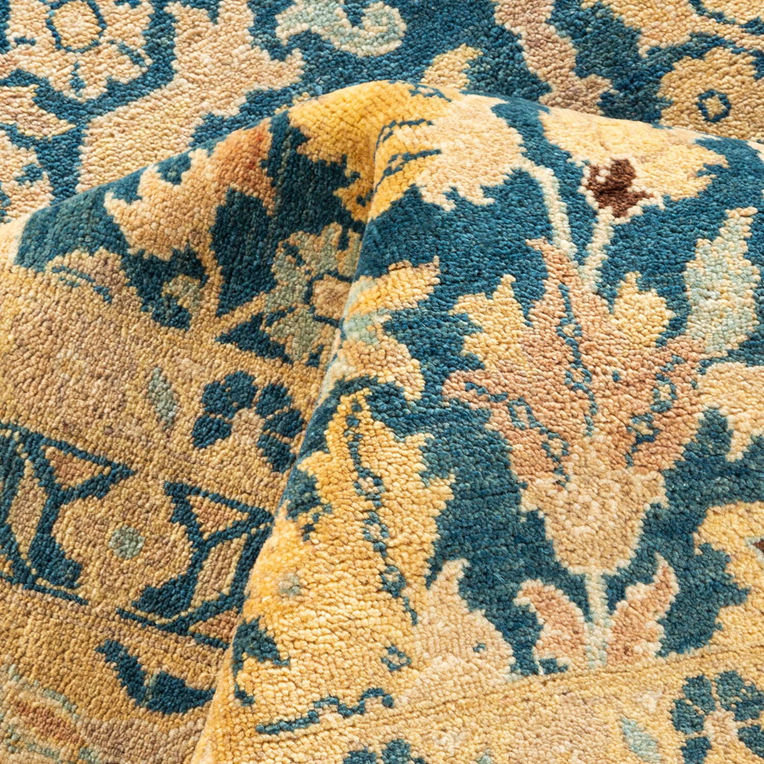 Close-up of a plush, ornate carpet with intricate floral design.