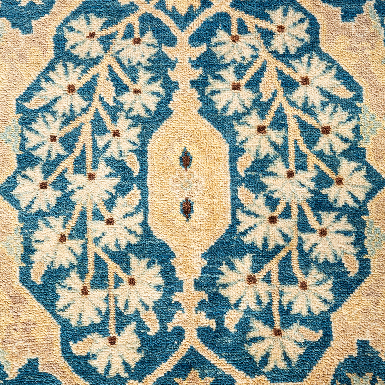 Close-up of a symmetrical, high-quality Middle Eastern carpet with floral motifs in blue and beige