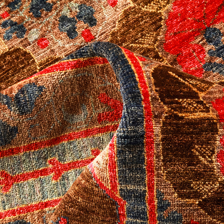 Intricate traditional rug showcasing geometric shapes with vibrant red and blue hues.