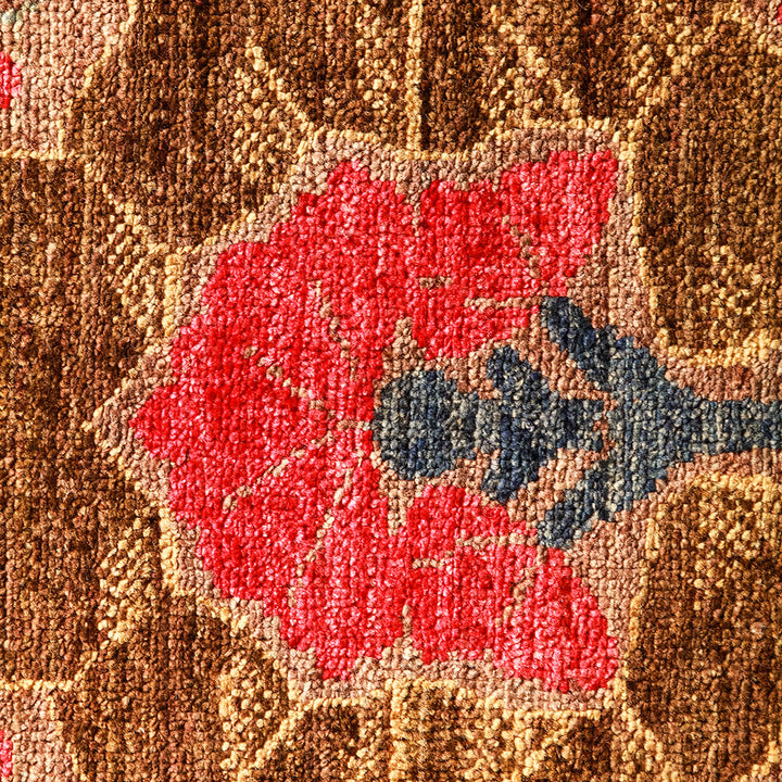 Close-up of intricate floral fabric pattern with red flower motif.