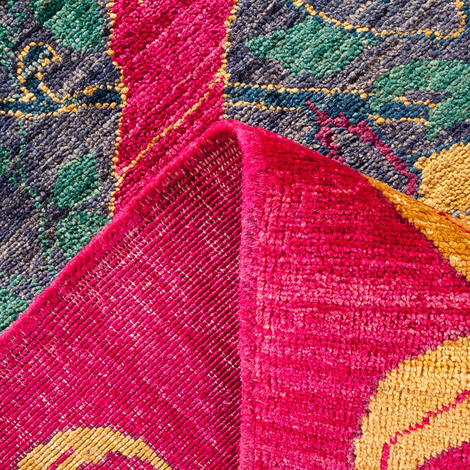 Close-up of a vibrant, thick textile with intricate geometric patterns.