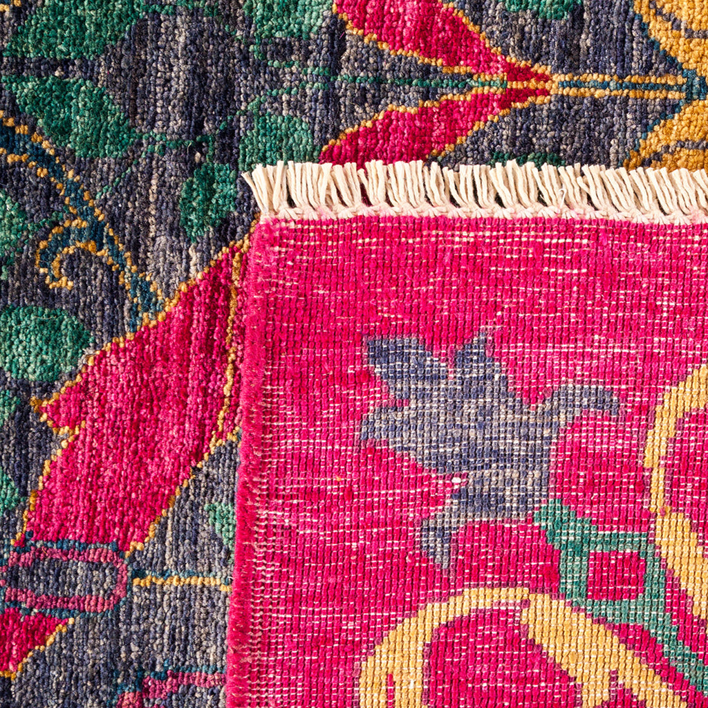 Intricately woven textile with floral-based symmetrical pattern in vibrant colors.