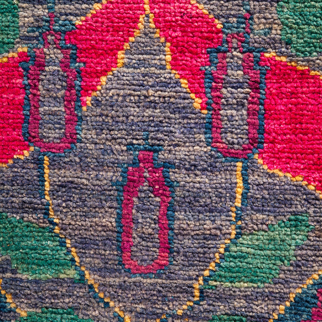 Close-up of a symmetrical, colorful textile with intricate geometric pattern