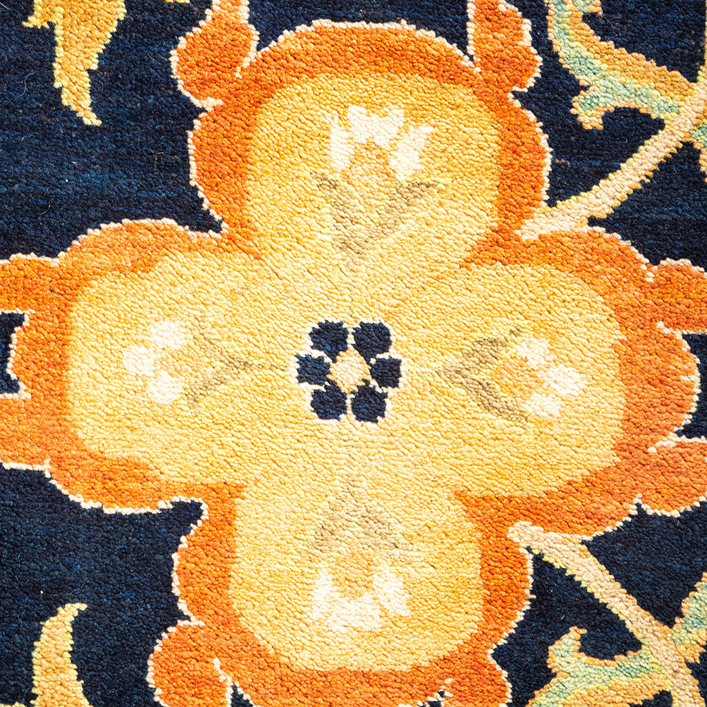 Close-up of a plush, ornate carpet with a floral pattern.