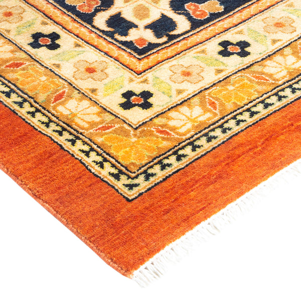 An ornately patterned rug with geometric and floral motifs in vibrant colors.