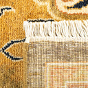 Close-up view of a vibrant, handwoven rug with fringe detailing.