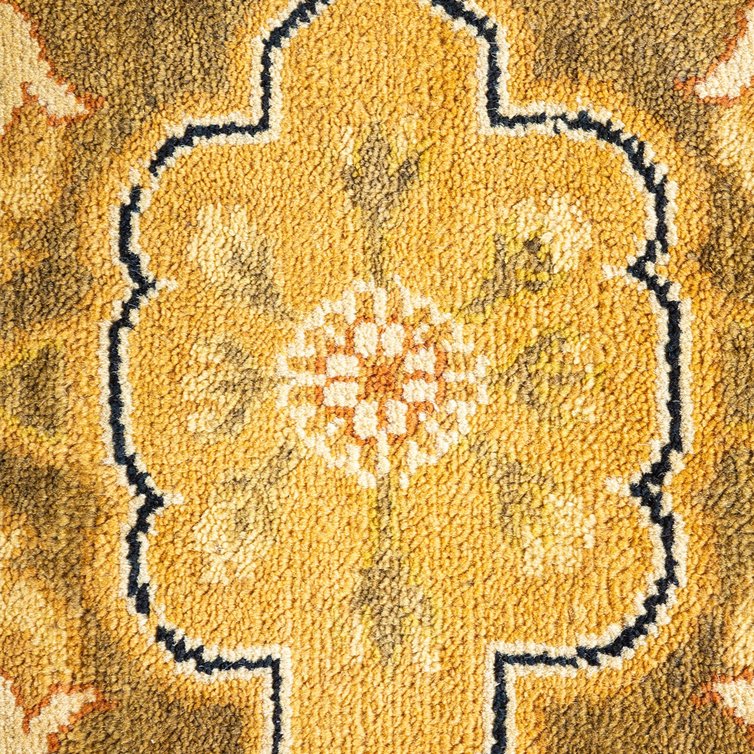 Detailed close-up of a yellow floral patterned fabric or carpet.