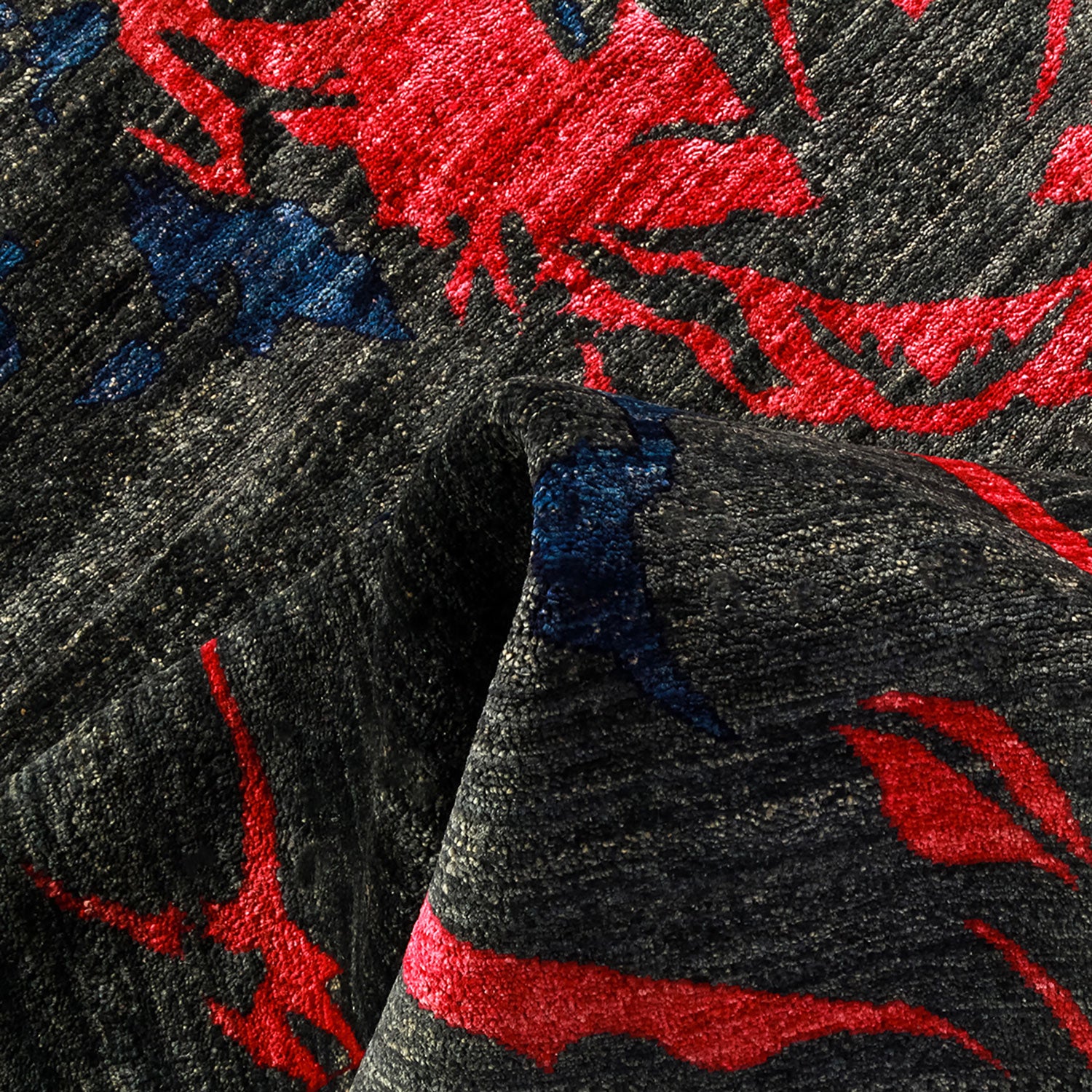 Close-up of textured fabric with bold black, red, and blue design.