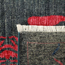 Close-up view of a woven textile with vibrant red motif