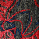 Close-up of colorful, textured fabric with red accents, possibly carpet.