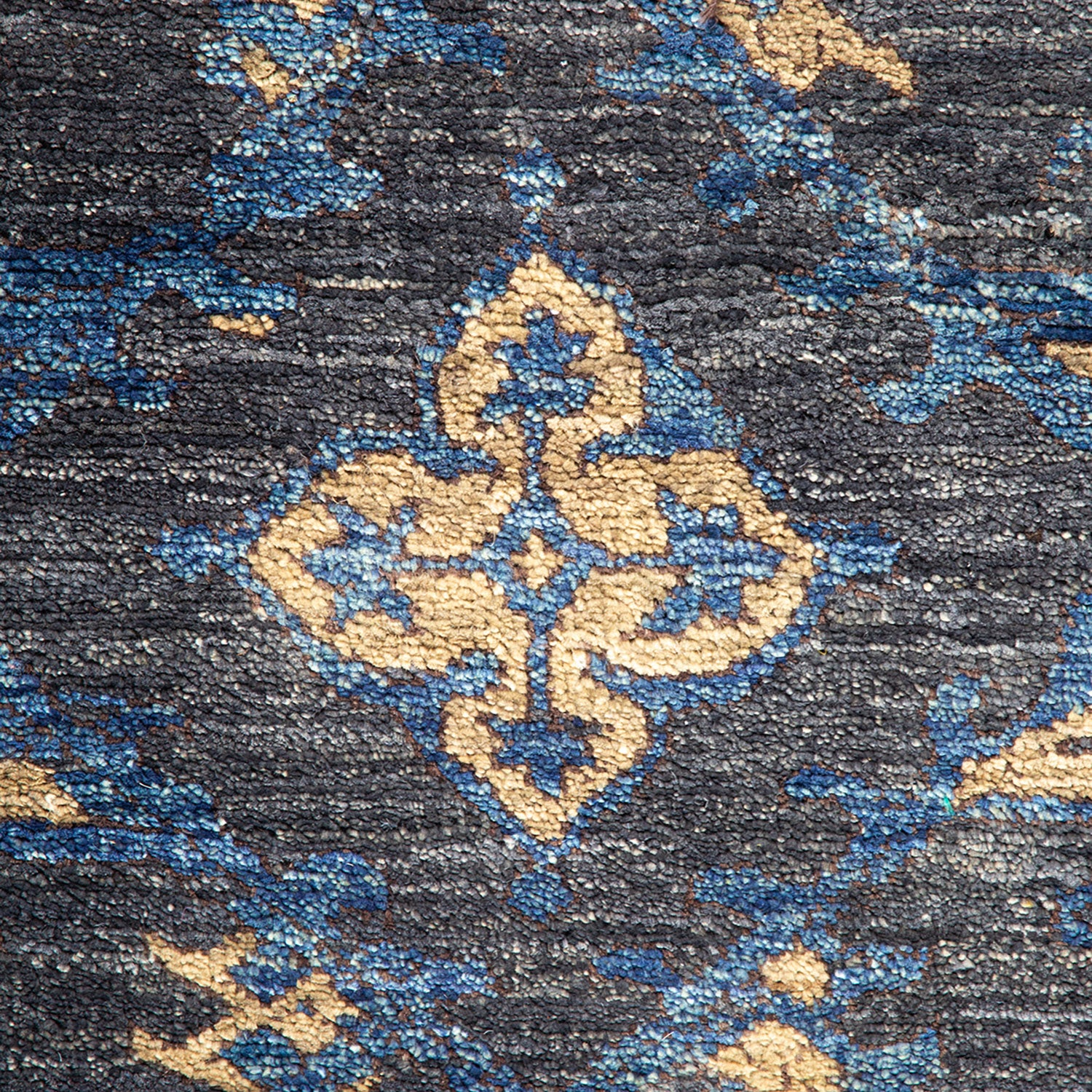 Intricate blue, gold, and grey fabric with ornate arabesque pattern.