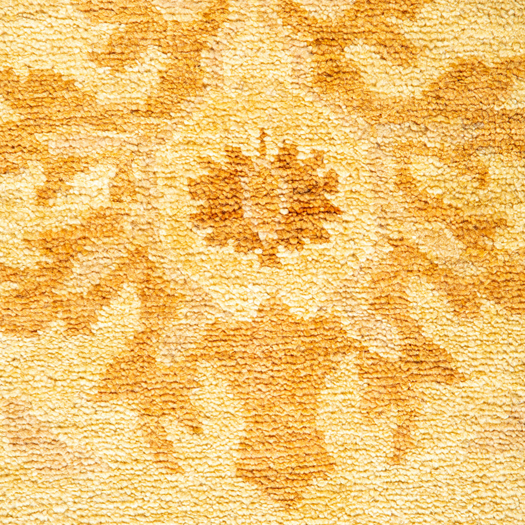 Close-up of a plush, yellow and brown floral patterned textile.