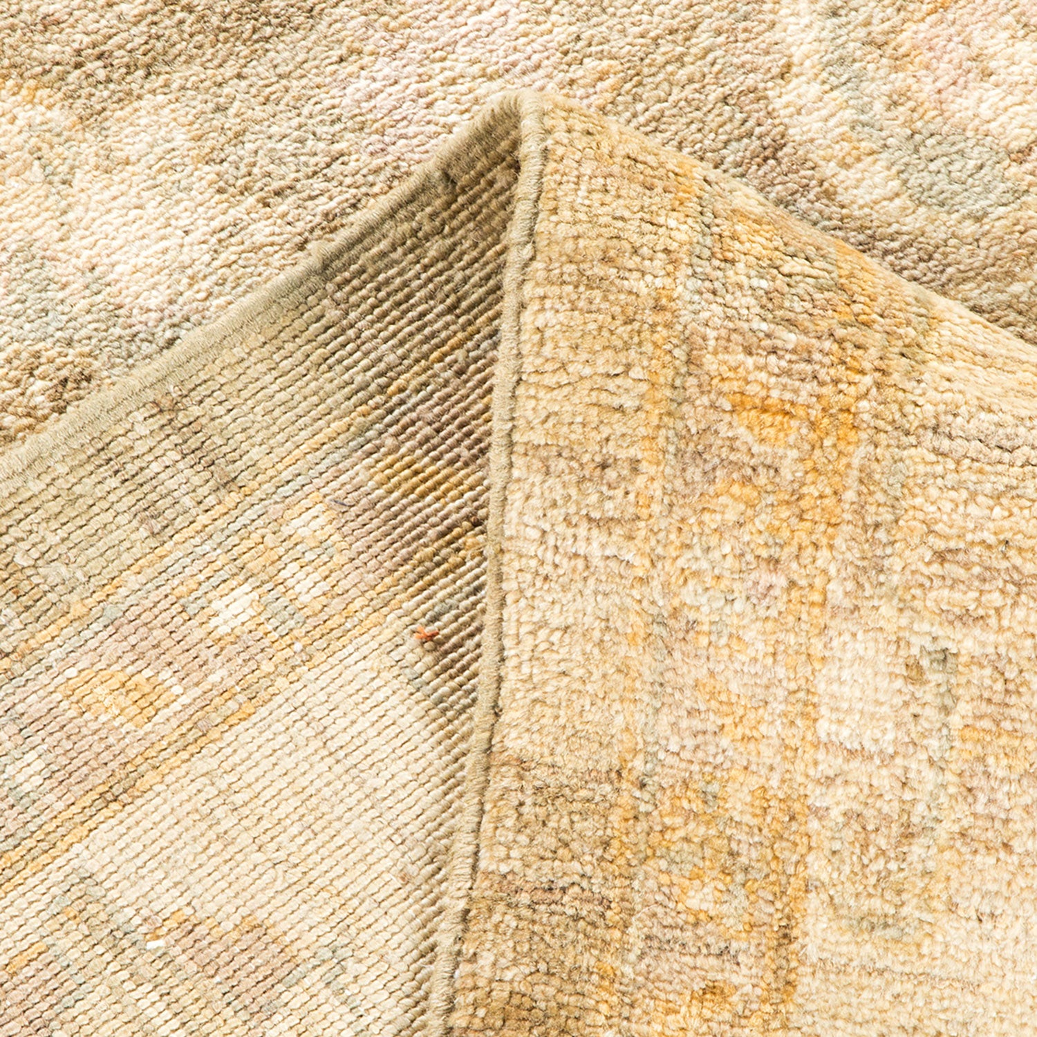 Close-up view of folded, plush fabric in neutral tones.