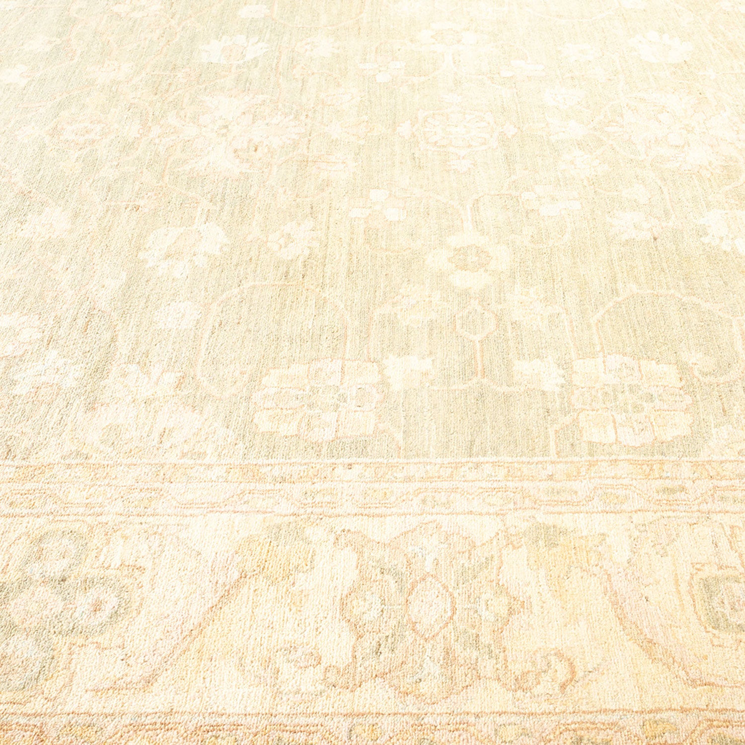 Delicate, ornate carpet in pale color with subtle floral patterns.