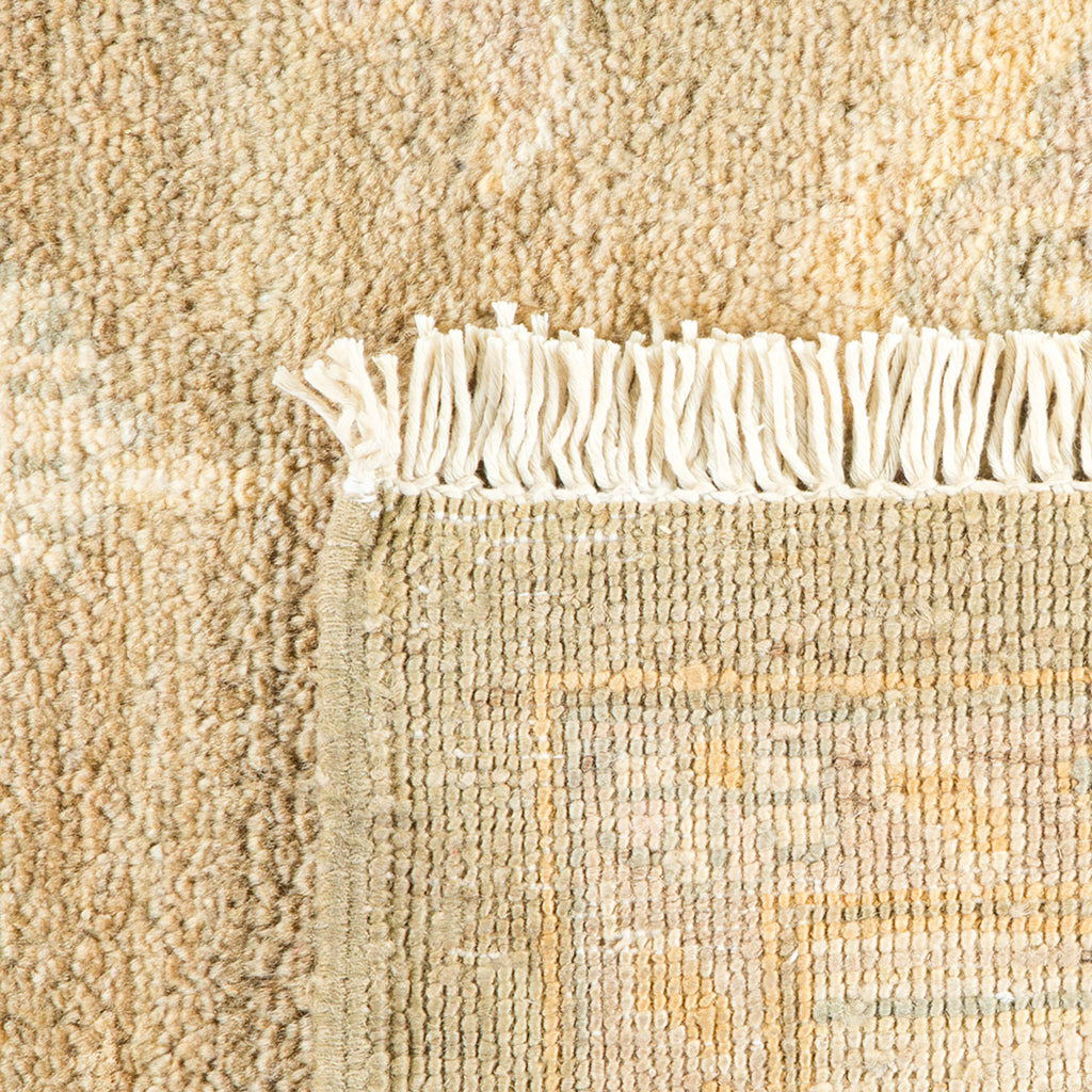 Close-up of a high-quality beige rug with a white fringe