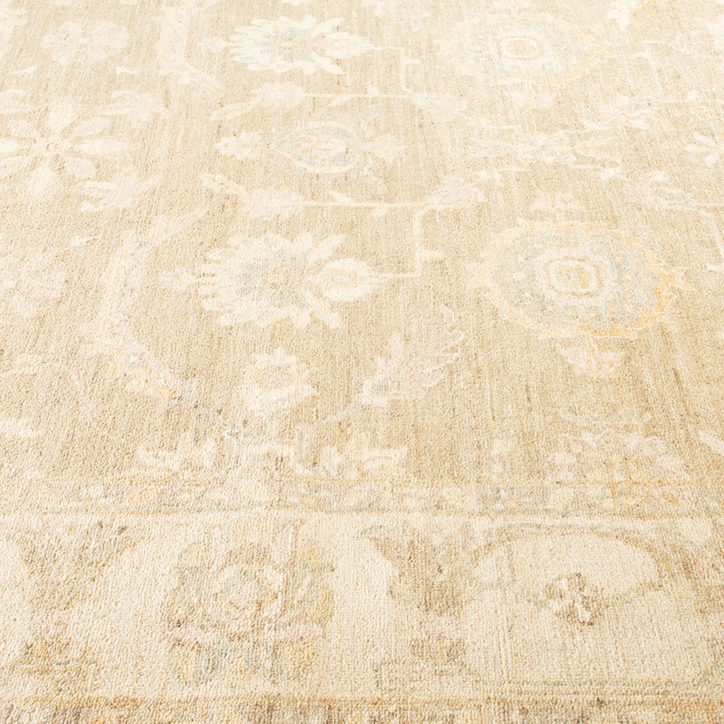 An elegant, light-colored rug with a subtle floral-geometric pattern.