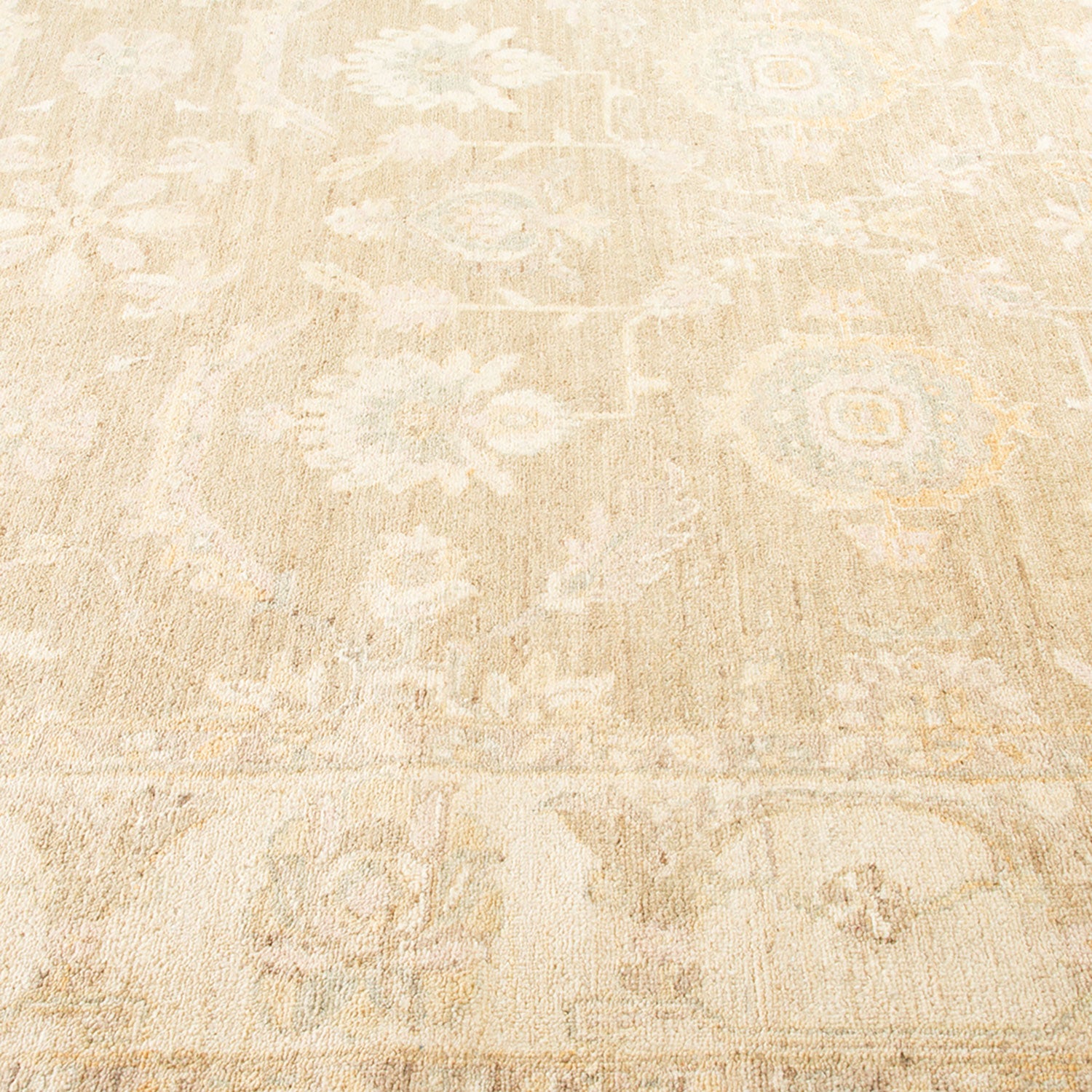 An elegant, light-colored rug with a subtle floral-geometric pattern.