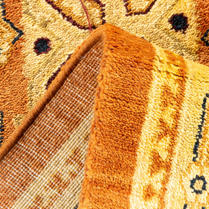 Close-up of a folded carpet showcasing intricate pattern and construction.