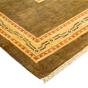 Handcrafted rug with geometric patterns and plush pile in gold.