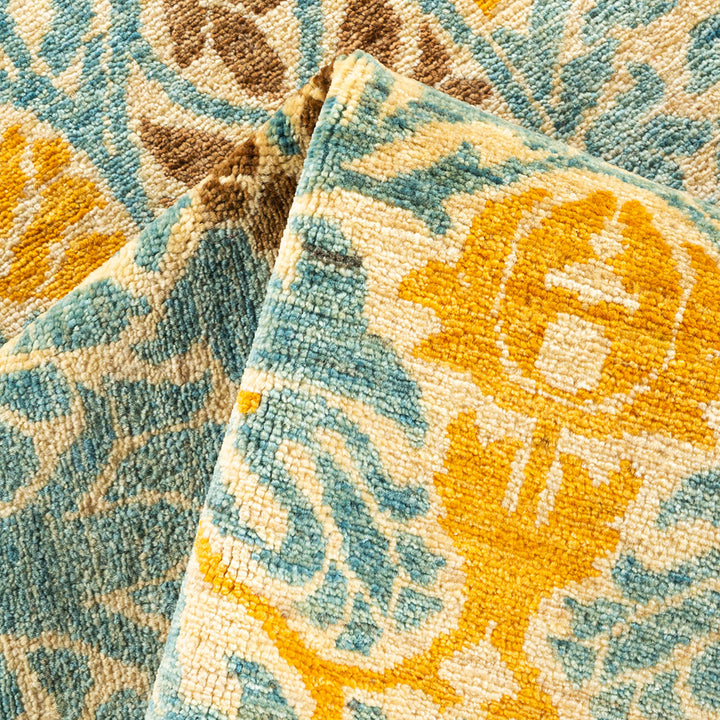 Intricately patterned rug in warm tones showcases plush, detailed design.